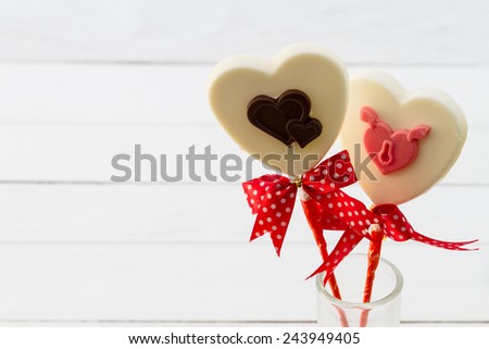 White chocolate hearts shape on white wooden floor