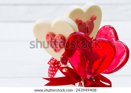 White chocolate heart shape on white wooden floor