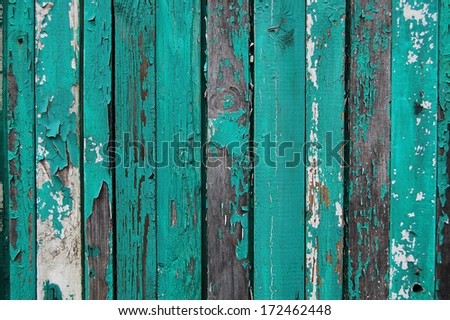 Wooden Palisade background. Close up of grey and green wooden fence panels. Vintage wood background. Old wooden fence. wood texture background. wood fence background