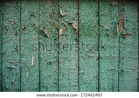 Wooden Palisade background. Close up of wooden fence panels.Old wooden fence. wood texture background. wood fence background.Old cracked paint pattern.Peeling paint. Damaged paint on the surface