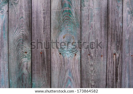 Wooden Palisade background. Close up of grey and green wooden fence panels. Vintage wood background. Old wooden fence. wood texture background. wood fence background. Wood wall