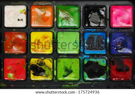art palette. color brush palette. Closeup of messy, used water-color paint-box.