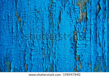 Cracked paint on a wooden wall. Wall from wooden planks with paint traces. old painted wood wall texture, grunge background, cracked paint.