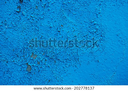 Old cracked paint pattern on concrete background. Peeling paint. Pattern of blue grunge material. Damaged paint. Scratched old plate