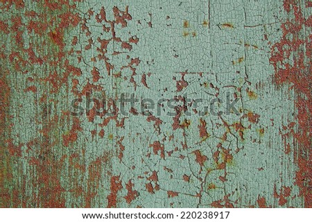 Green cracked paint on metal rusty surface