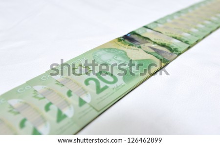 MONTREAL - NOVEMBER 19: The new polymer twenty dollar bill, which is the most widely used bank note in the country, is pictured on November 19, 2012 in Montreal, Quebec, Canada.