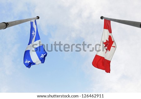 MONTREAL - JULY 1: Quebec and Canada National flags are flying on national day of Canada, on July 1, 2009 in Montreal, Quebec, Canada.