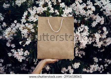 a paper bag on a background of white flowers