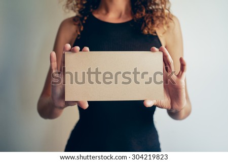 woman showing a brown blank page of clipboard
