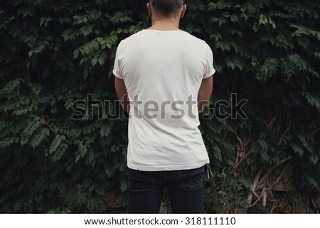 young man in white t-shirt. Back view