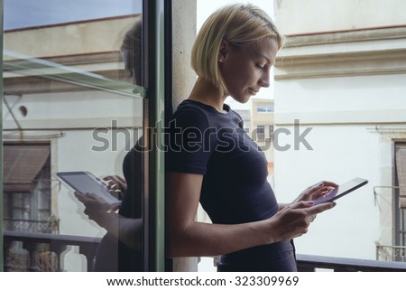 young woman using tablet on the balcony