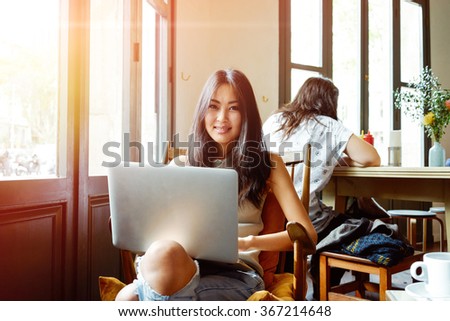 Casual asian young woman using laptop for distance job at coffee shop.portrait of an attractive girl who communicates online on her PC