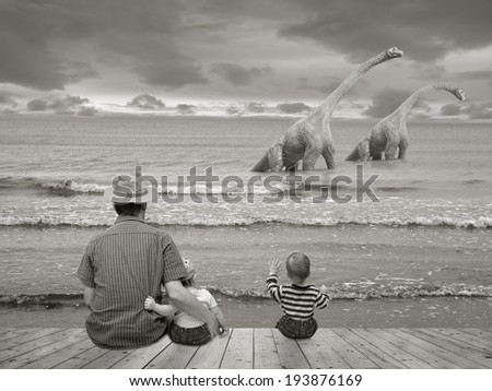 Father with children watching two dinosaurs in the Sea