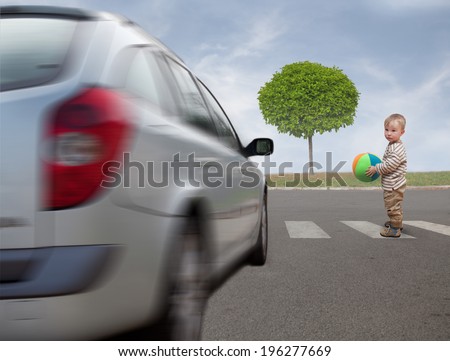 baby with ball tries to cross the road