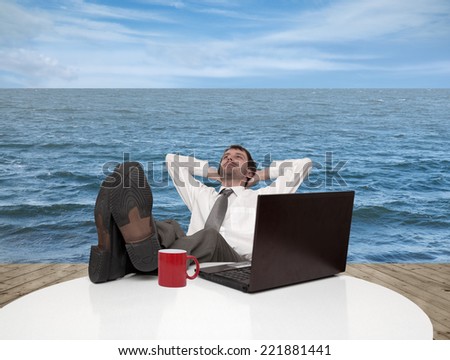 Young businessman relaxes on a pier by the sea