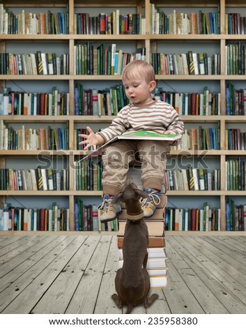 child reading a book in the library and dog