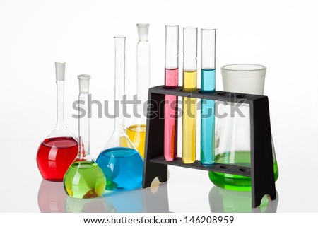 Chemistry set with  test-tubes and beakers filled with multicolored liquids.