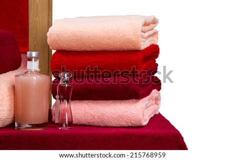 a neat stack of terry towels on a rack isolated on white background