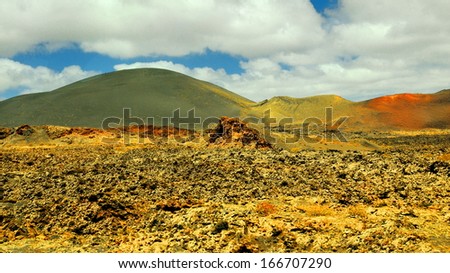Arid landscape with volcanoes, in Timanfaya National Park, Lanzarote, Spain