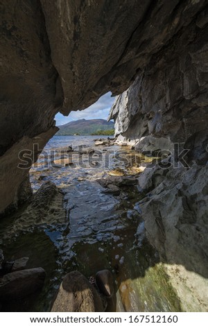 Window cave in rock cliff just above sea level, Ireland
