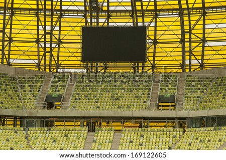 yellow seats and electronic billboard display at stadium