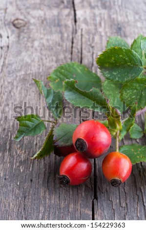 Rosehip berries on a old textured wooden background