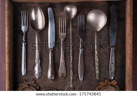 Old cutlery in an old wooden box