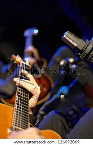 Two jazz guitars and microphone on stage