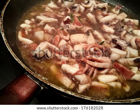 Close view on the pan with Cuttlefish cooking in the red vine sauce/Cuttlefish in red vine sauce