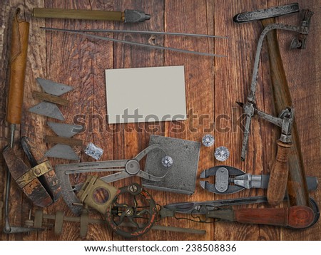 vintage jeweler tools and diamonds over wooden bench, blank card for your business