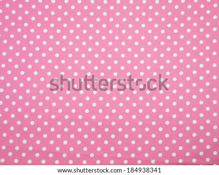 Seamless pink and white polka dot fabric background
