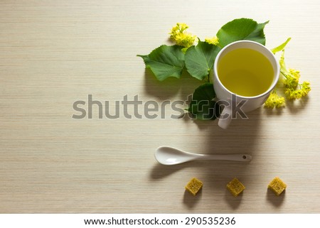 Linden tea cup with linden flowers on textured background