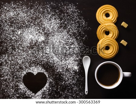 Minimalist breakfast with coffee, biscuits, brown sugar cubes, and heart shape made in flour
