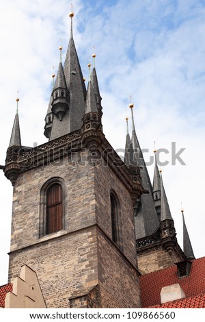 Classical gothic architecture. Red tiling roofs near high ancient towers. Prague,Czech Republic