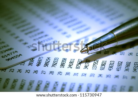 Closeup of pen on abstract number background