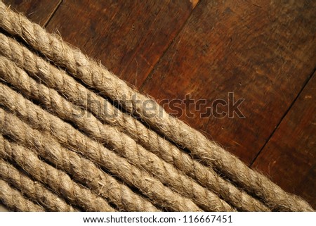 Old hemp rope on dark wooden surface