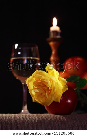 Vintage still life with beautiful yellow rose near white wine and fruits