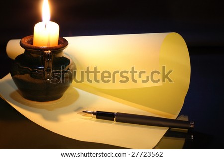 Candle paper pen on dark background