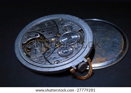 Opened old watch on dark background