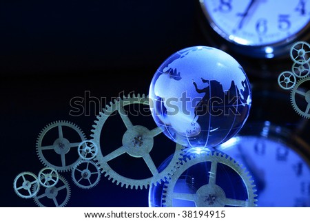 Glass globe on dark background with clock dial and gears