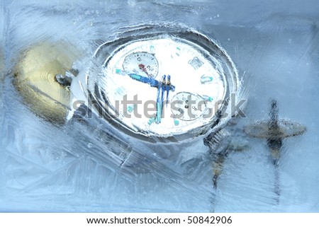 Closeup of wrist watch and gears under frozen water