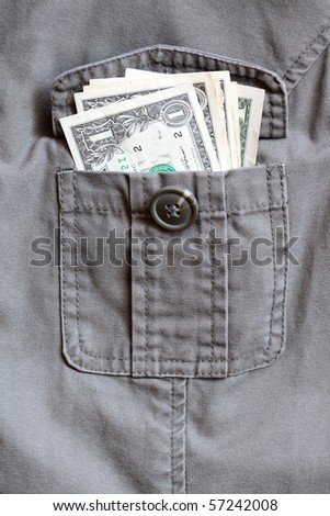 One dollar bank notes inside open khaki jacket pocket