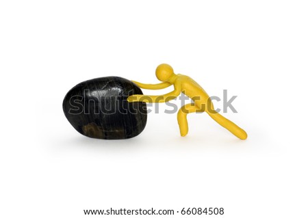 Yellow plasticine man pushing black stone. Isolated on white with clipping path