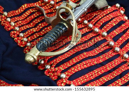Closeup of elegance antique sword lying on old Russian military uniform