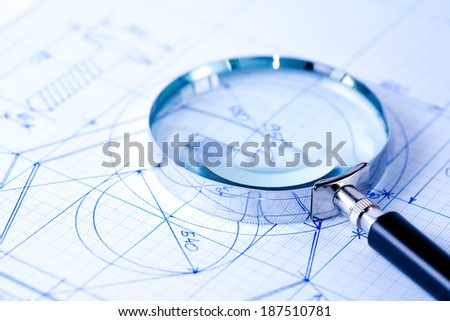 Business concept. Magnifying glass on graph paper with design