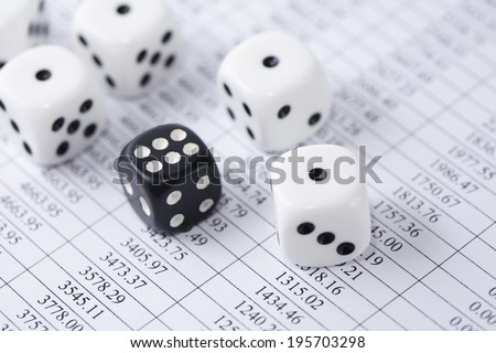 Business concept. Dice play on paper background with table of digits