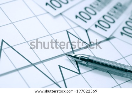 European Union Currency near pen on paper background with chart