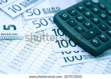 Financial background. European Union Currency near calculator on paper background with digits table