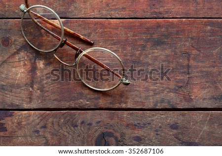 Old vintage spectacles on nice wooden background