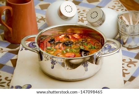 A spicy soup with vegetables and meat or fish.